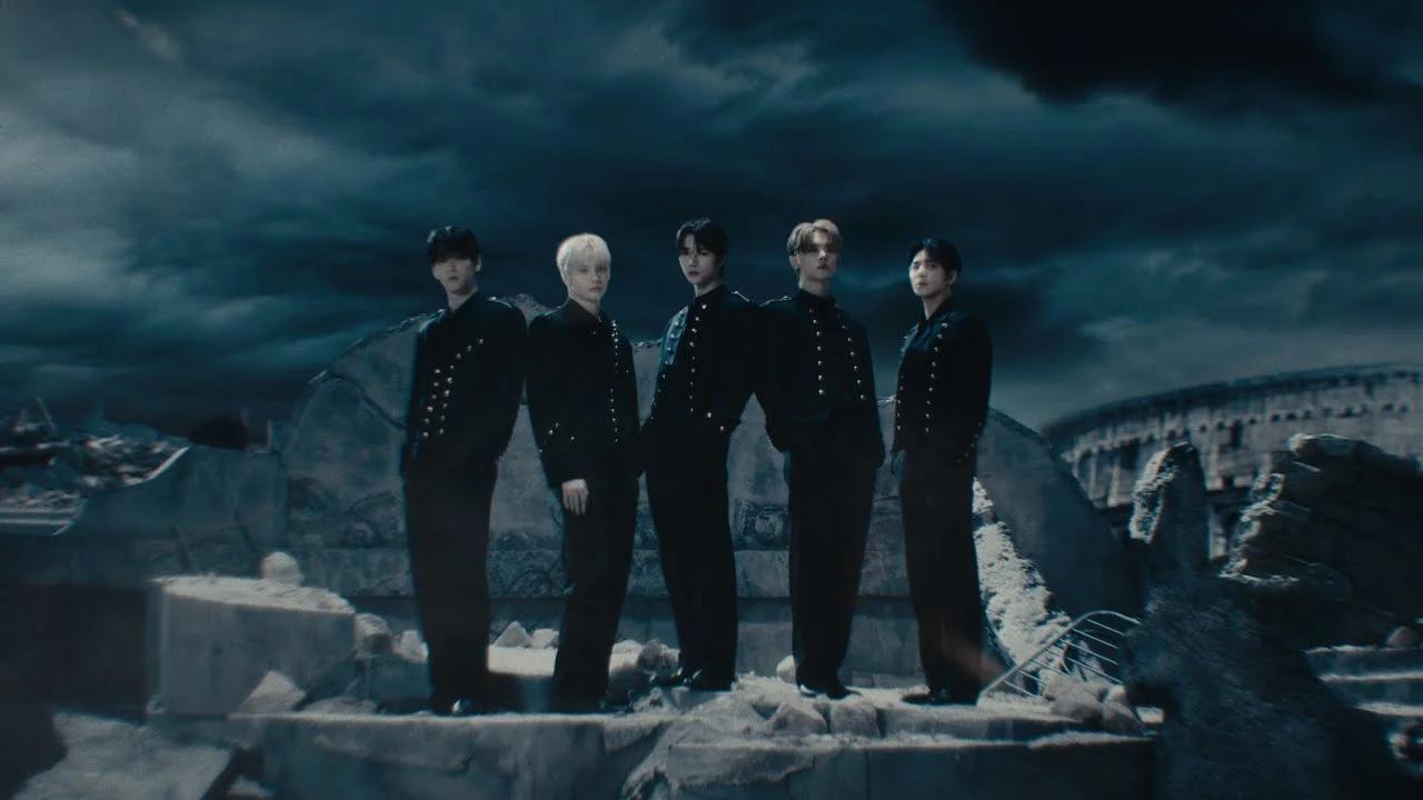 TXT TOMORROW X TOGETHER ACT TOMORROW world tour, five members in black military jackets against a cinematic backdrop