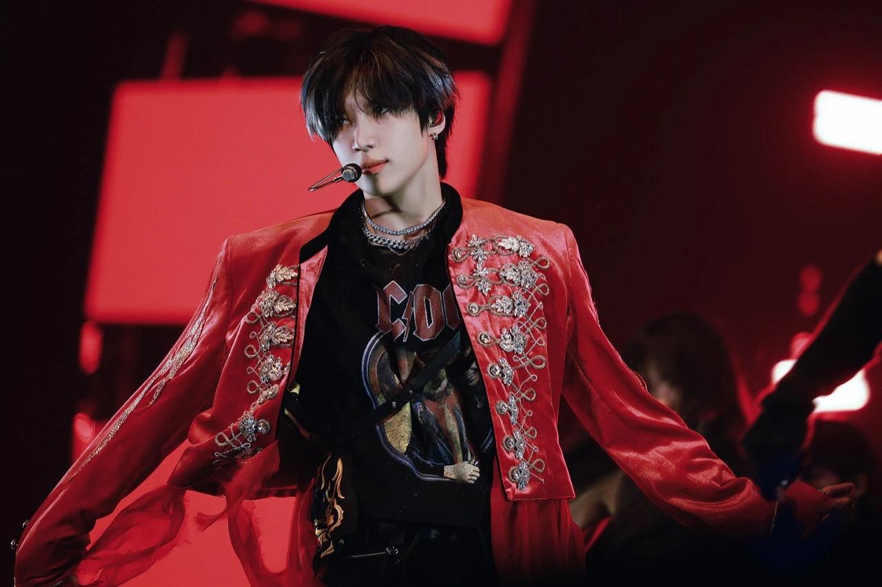 Taemin performing live in a red embroidered blazer, now a Grammy Museum-recognized K-pop icon