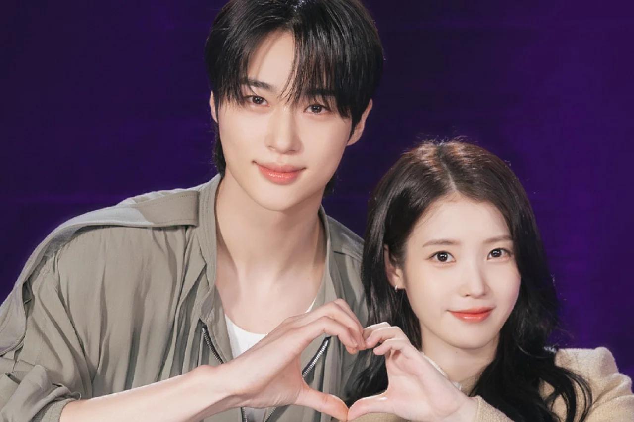 Byeon Woo-seok and IU at a press event, making heart gestures