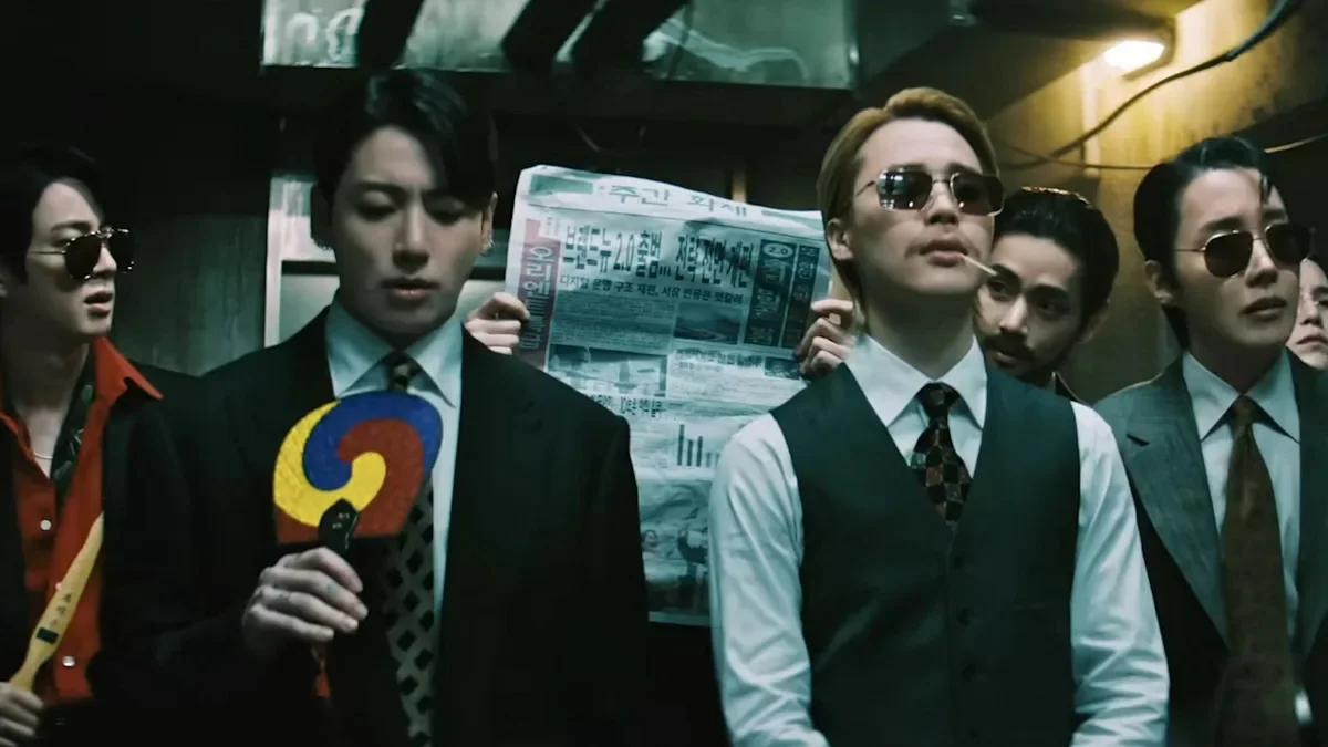 BTS members in suits walking through dark corridor in the 2.0 music video, referencing Oldboy