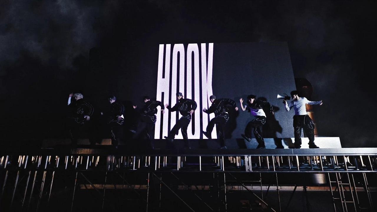 MODYSSEY performing in front of a giant HOOK backdrop in the official music video thumbnail