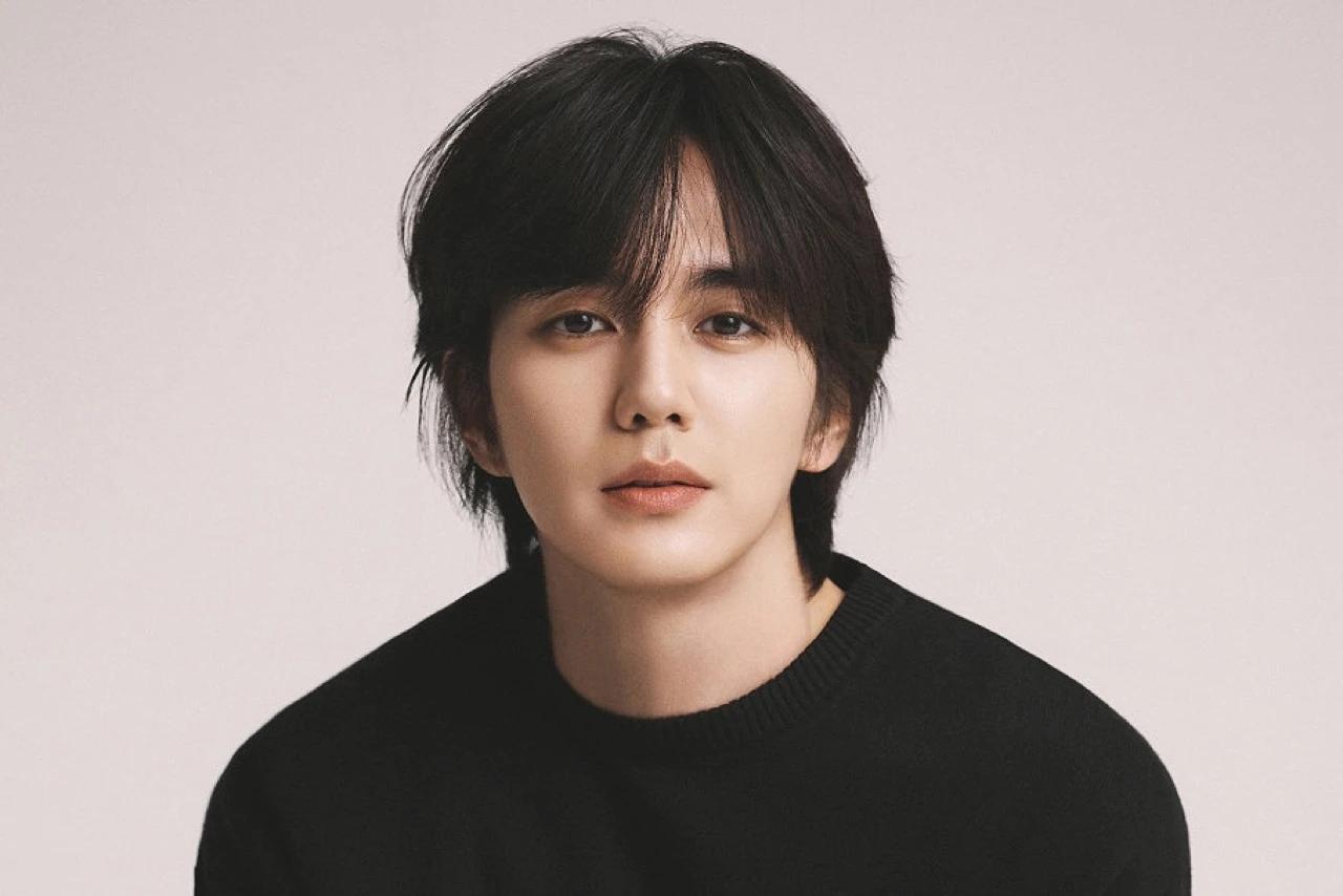 Yoo Seung Ho in a professional publicity portrait wearing a black knit top against a light background