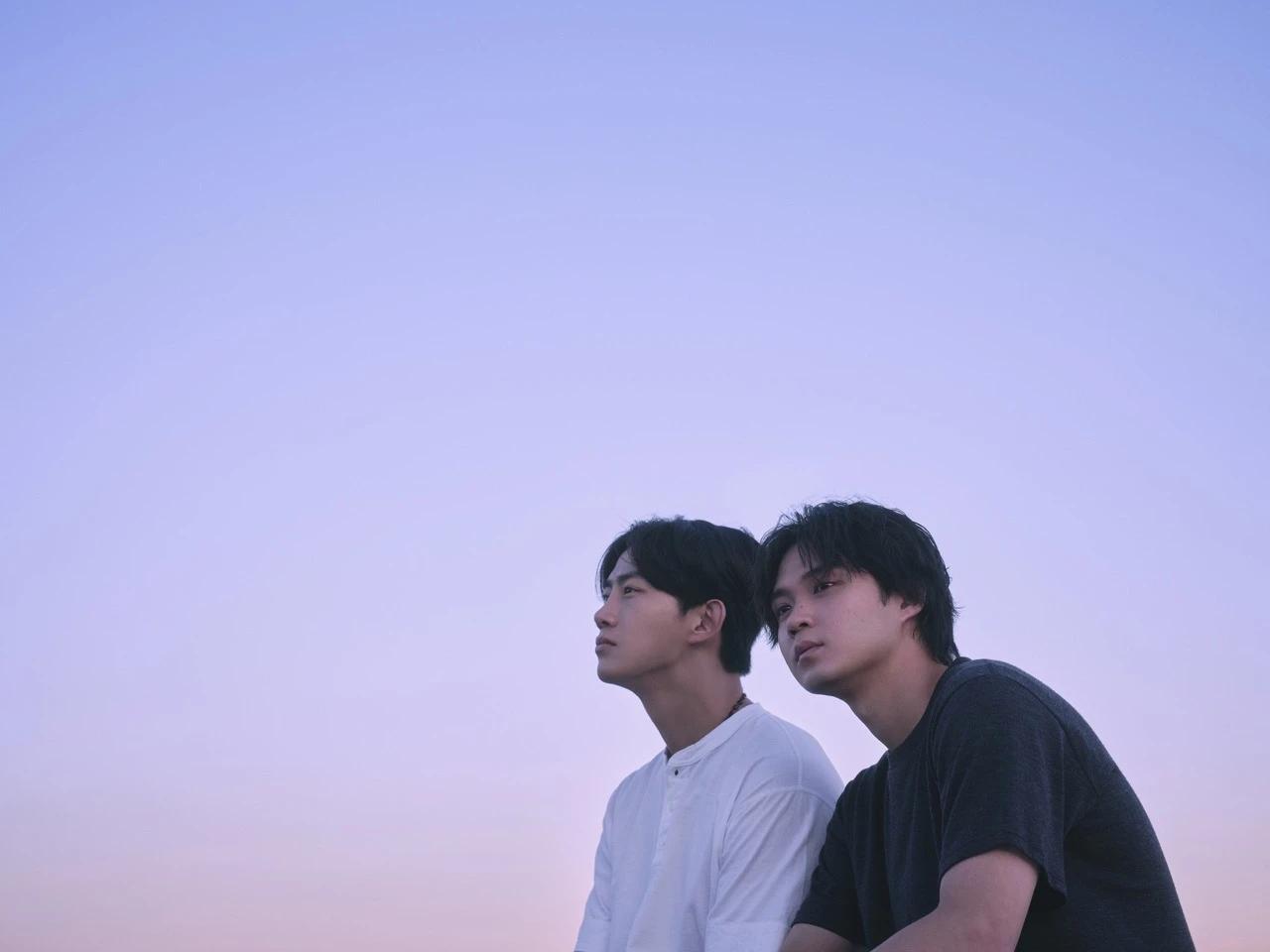 Two lead characters from Netflix's Soul Mate sit under a pastel sky in official first-look art shared by Netflix.