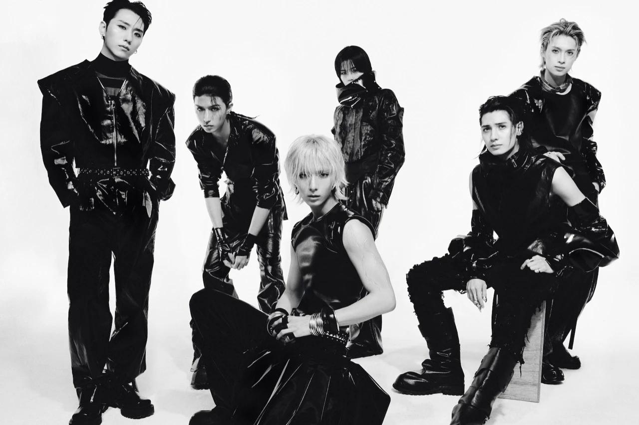 Xdinary Heroes in a black-and-white promotional group photo for The New Xcene era