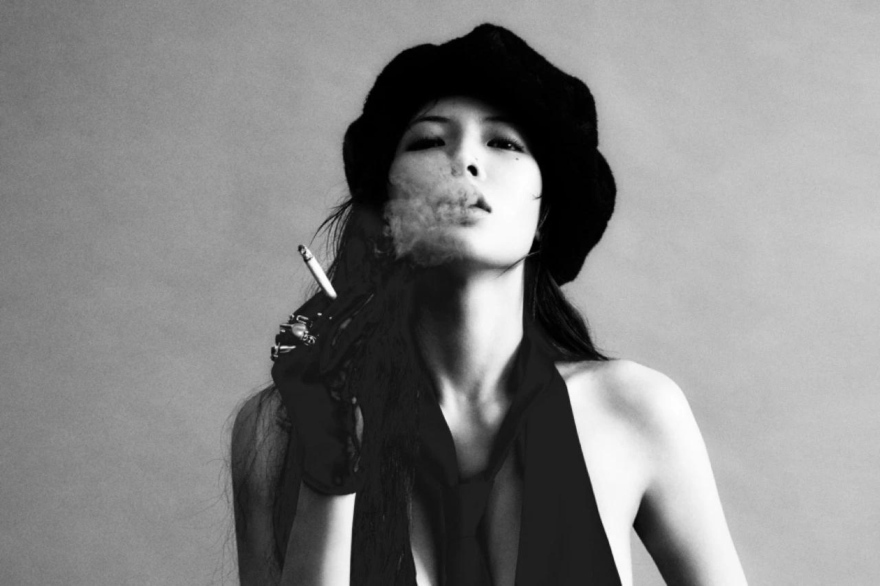 HyunA in an official black-and-white AT AREA profile photo wearing a beret and black stagewear