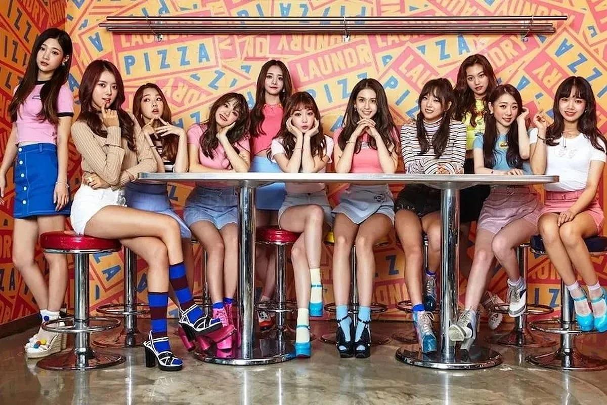 I.O.I members seated together in a colorful retro diner-style concept photo